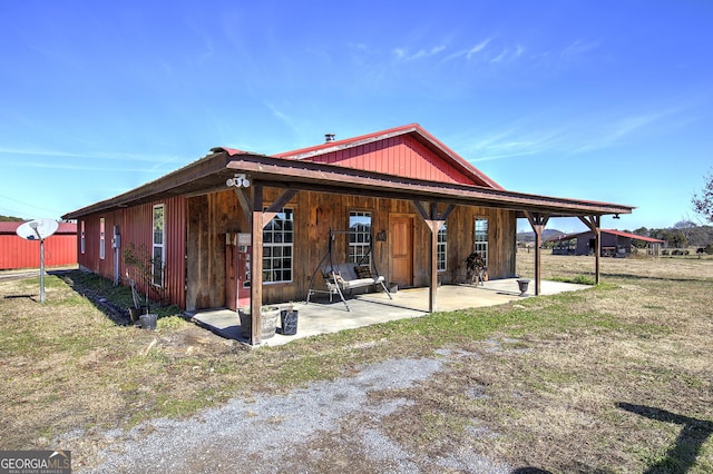 back of house with a patio