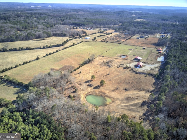 bird's eye view featuring a forest view and a rural view