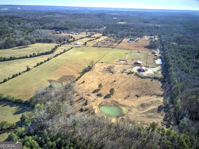 birds eye view of property featuring a rural view and a forest view