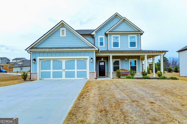 craftsman-style house featuring a garage, a front yard, and a porch