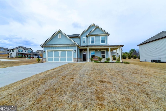 craftsman-style home featuring a garage, central AC, a front lawn, and covered porch