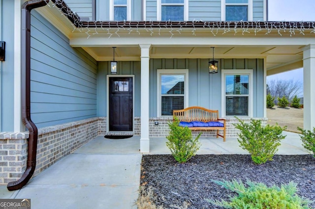 view of exterior entry featuring a porch