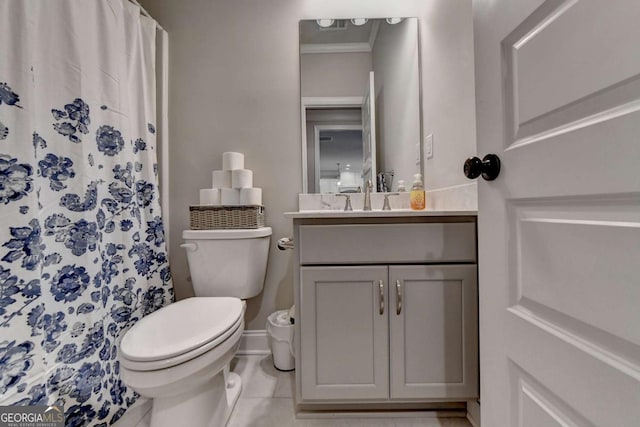 bathroom with vanity, ornamental molding, tile patterned floors, and toilet