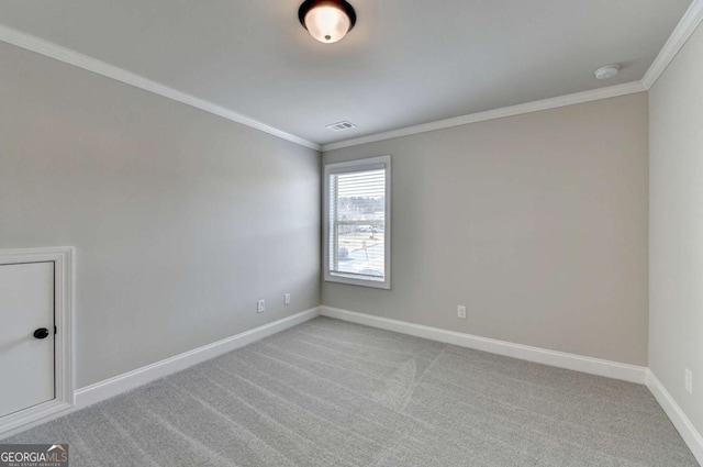 carpeted spare room featuring ornamental molding