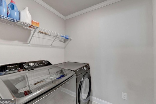 laundry room featuring crown molding and washer and clothes dryer