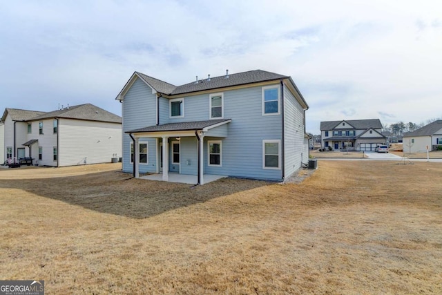 rear view of house with a yard and a patio area