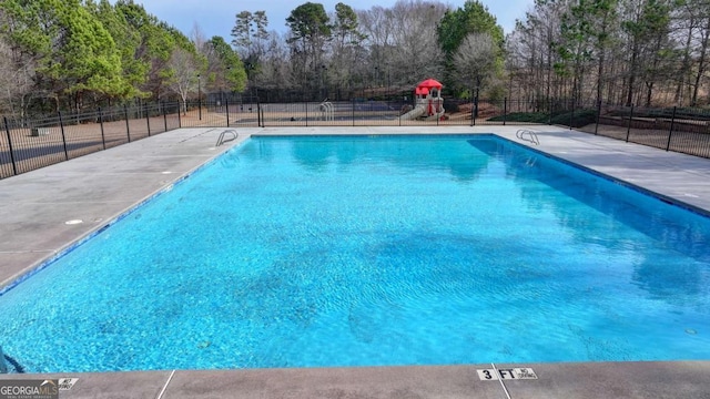 view of pool featuring a playground