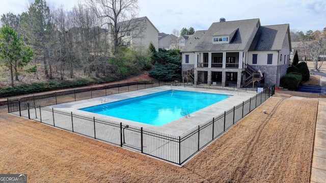 view of swimming pool featuring a lawn and a patio area