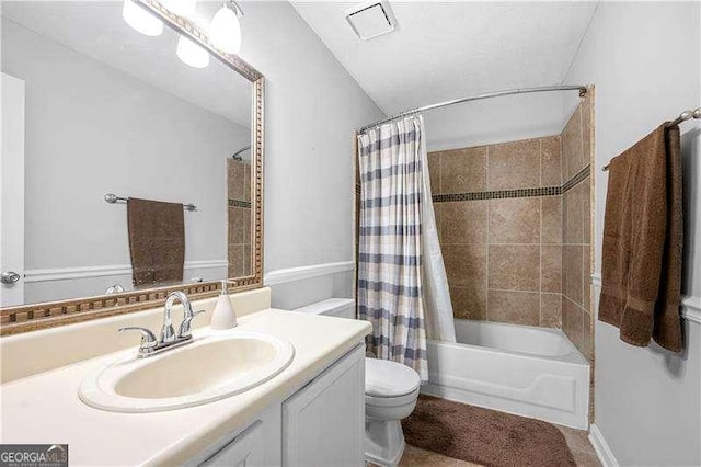 full bathroom with vanity, toilet, and shower / tub combo