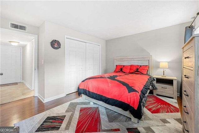 bedroom with hardwood / wood-style floors and a closet