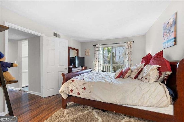 bedroom with dark wood-type flooring