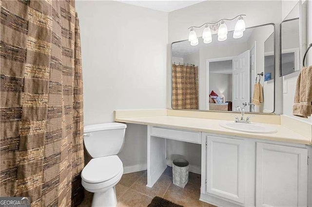 bathroom featuring tile patterned floors, vanity, and toilet