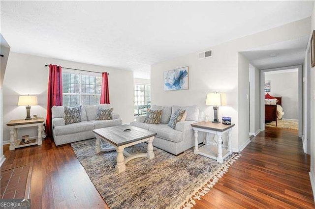 living room with dark hardwood / wood-style flooring