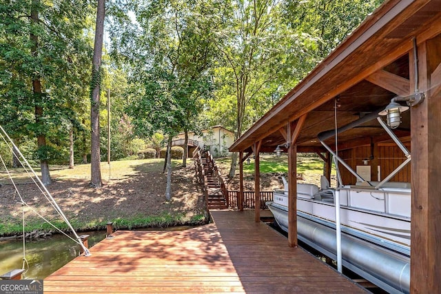 dock area with stairway and a water view