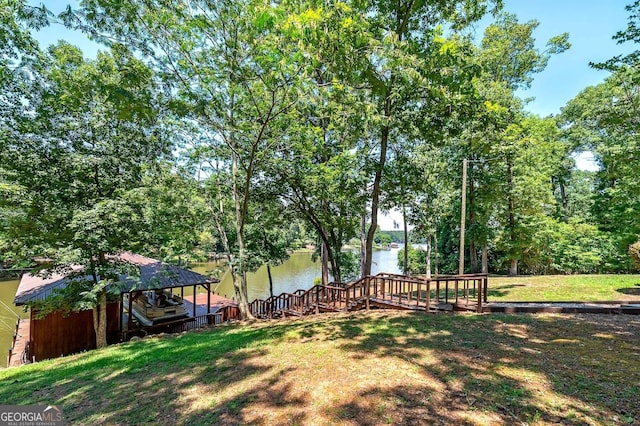 view of yard featuring a dock and a water view