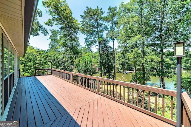 wooden terrace featuring a water view