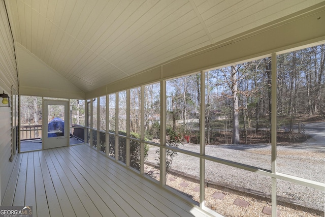 unfurnished sunroom featuring lofted ceiling and wooden ceiling