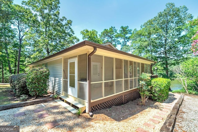 view of outbuilding with a sunroom