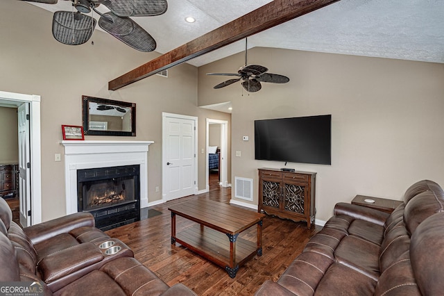 living room featuring dark wood-style floors, beam ceiling, a fireplace with flush hearth, and visible vents