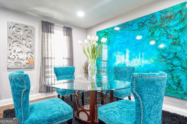 dining area featuring baseboards and wood finished floors