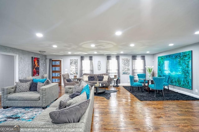 living room with baseboards, wood finished floors, and recessed lighting