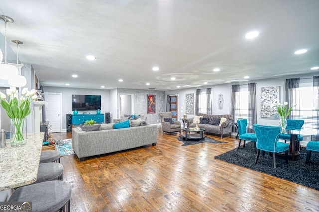 living area with recessed lighting and wood finished floors