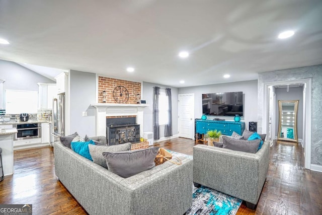 living area with a fireplace, dark wood finished floors, recessed lighting, vaulted ceiling, and baseboards