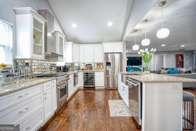 kitchen with dark wood finished floors, wine cooler, glass insert cabinets, vaulted ceiling, and stainless steel appliances