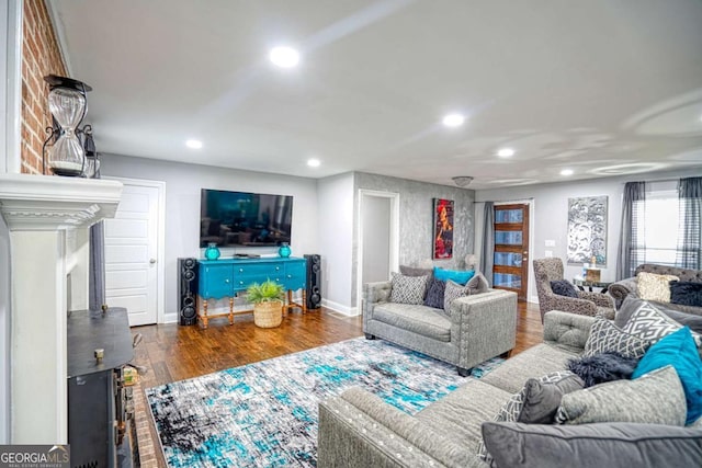 living room with recessed lighting, baseboards, and wood finished floors