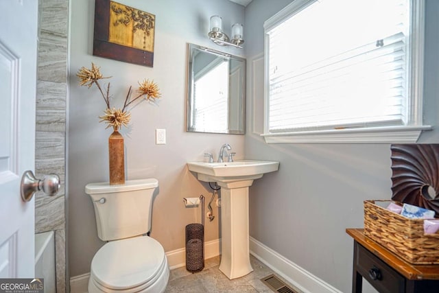 bathroom featuring visible vents, toilet, and baseboards