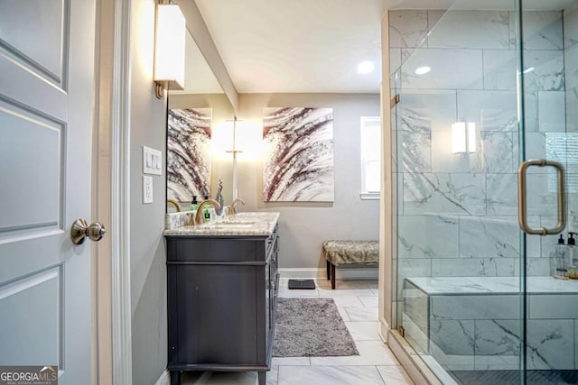 full bath with marble finish floor, baseboards, a stall shower, and vanity