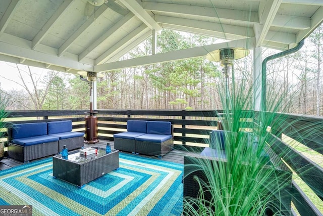 wooden terrace with an outdoor hangout area