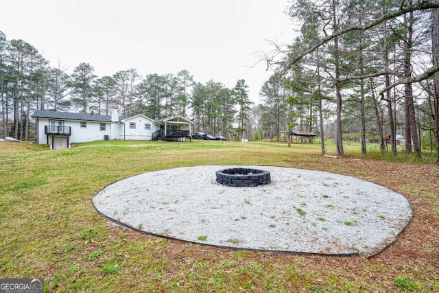 view of yard with an outdoor fire pit