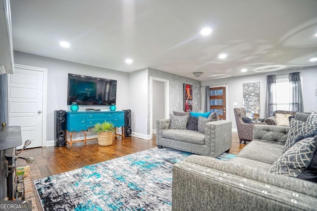 living room with baseboards, wood finished floors, and recessed lighting