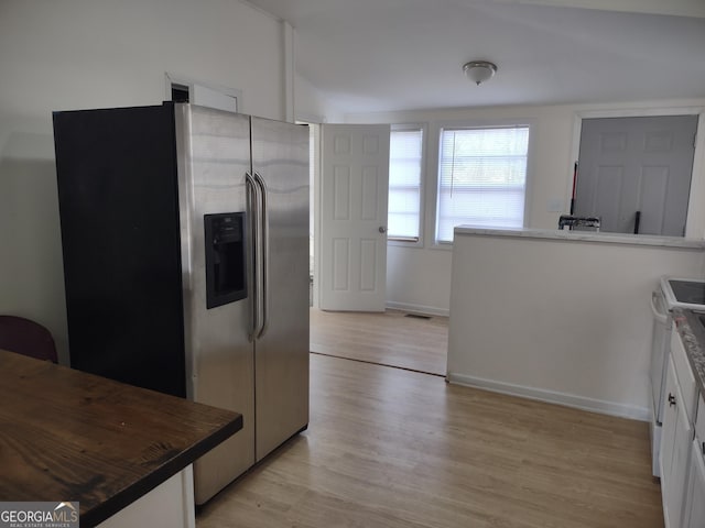 kitchen with white cabinetry, light hardwood / wood-style floors, stainless steel fridge with ice dispenser, and white range with electric stovetop