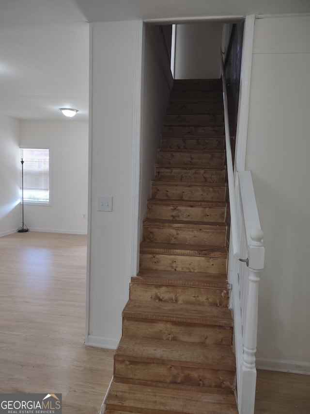 stairs with wood-type flooring