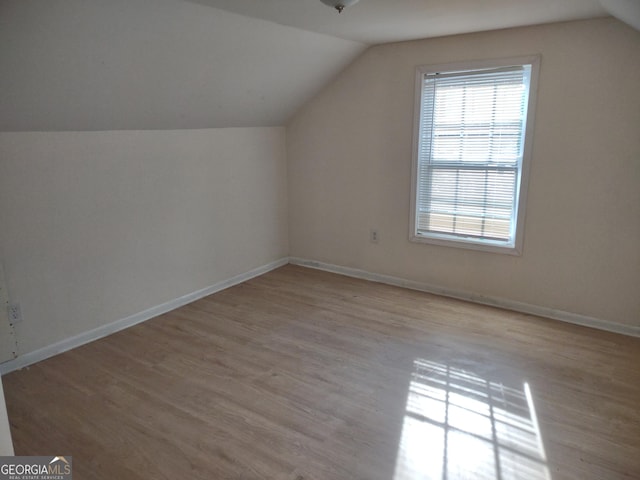 bonus room featuring vaulted ceiling and light hardwood / wood-style floors