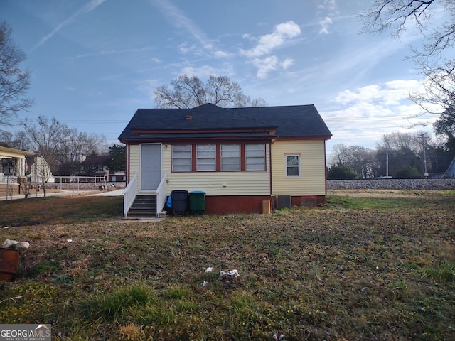 rear view of house with central AC unit