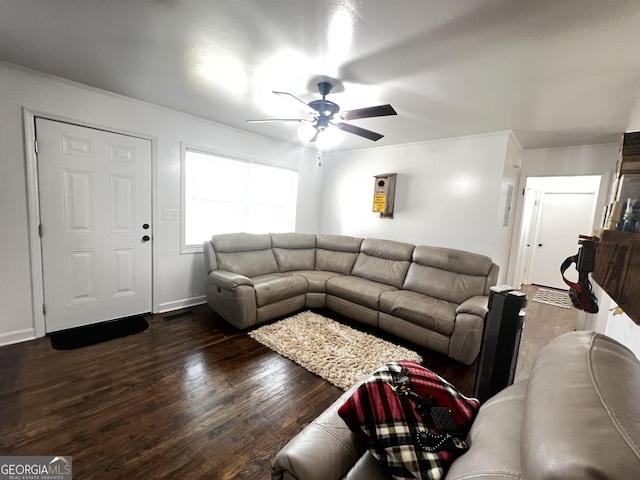 living room featuring ceiling fan and dark hardwood / wood-style flooring