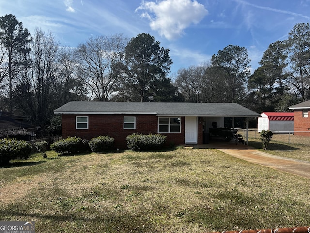 ranch-style house featuring an attached carport, driveway, a front lawn, and fence