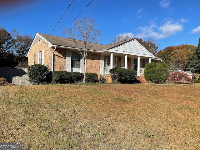 view of front of home with a porch and a front lawn