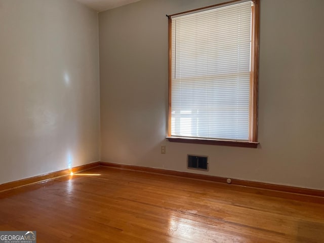 spare room featuring light hardwood / wood-style flooring