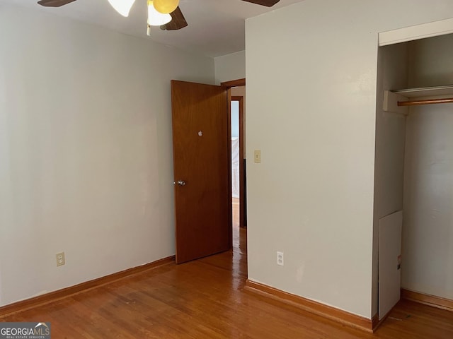 unfurnished bedroom with ceiling fan and hardwood / wood-style floors