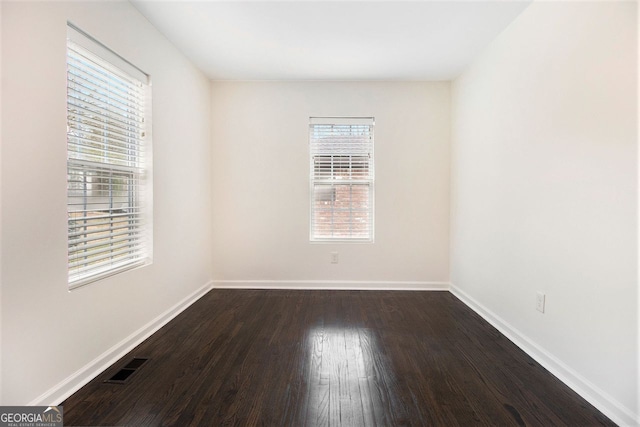 spare room with dark hardwood / wood-style flooring