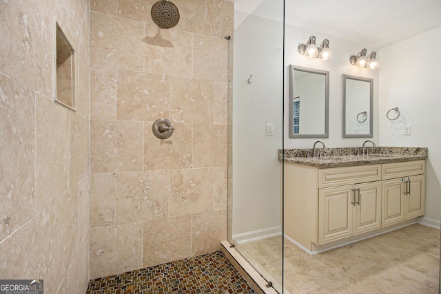 bathroom with vanity and tiled shower