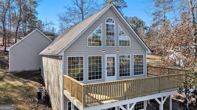 rear view of house with a wooden deck and central air condition unit