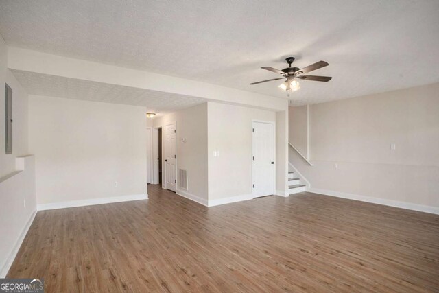 spare room featuring a textured ceiling, dark hardwood / wood-style floors, and ceiling fan