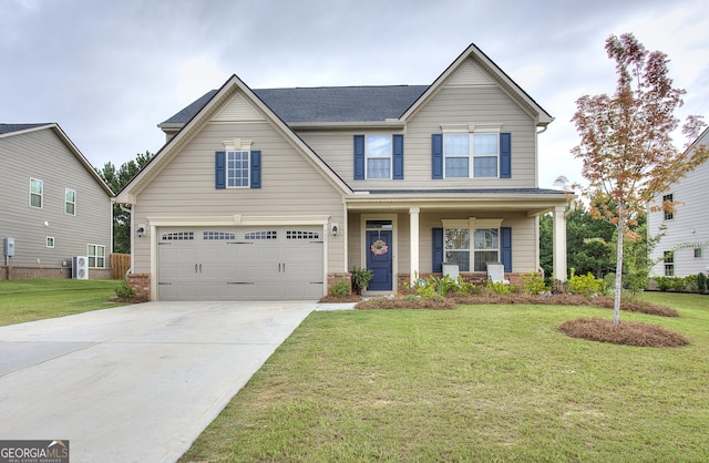 view of front of property with a garage, a front yard, and covered porch