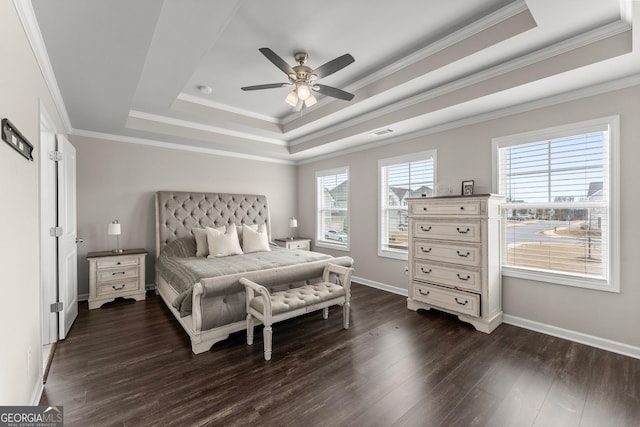 bedroom with ornamental molding, dark hardwood / wood-style flooring, and a raised ceiling