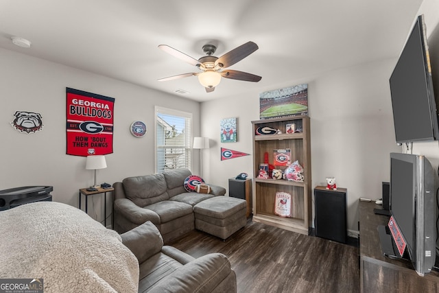 living room featuring dark wood-type flooring and ceiling fan